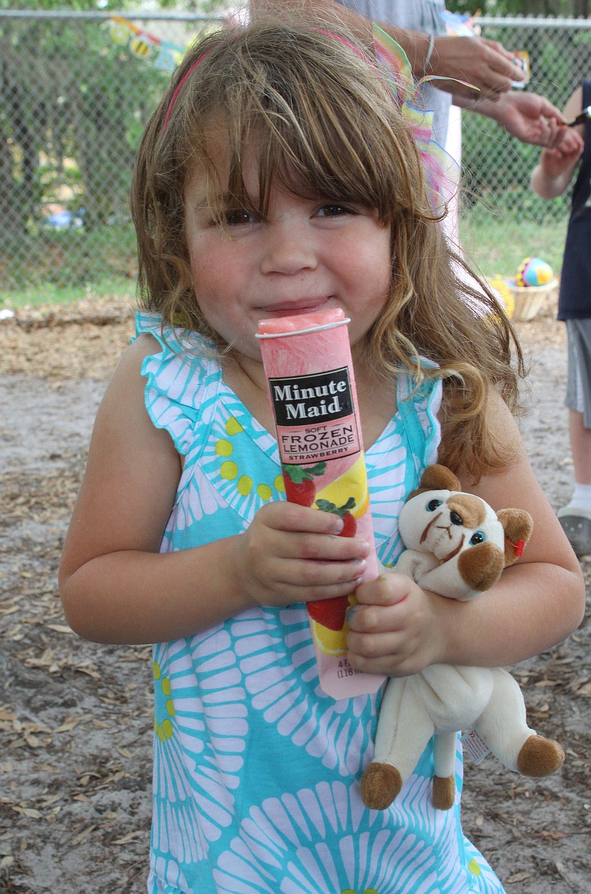 Selah Ocasio, 4, enjoys her ice pop and her new Beanie Baby after searching for eggs at the Face Autism Egg Hunt.