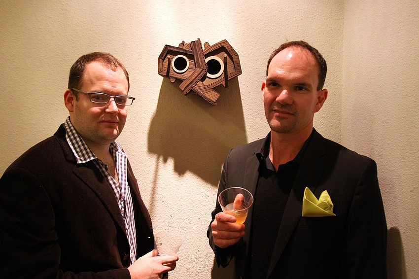 Nathan Skiles and Jeff Schwartz pose in front of one of Skileses birdhouses.
