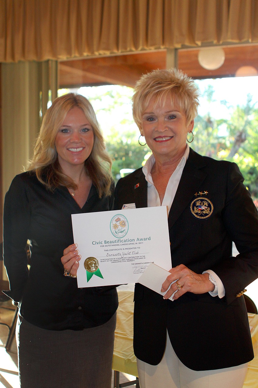 Dana Soldati and Commodore Willa Saalwaechter accepted the Civic Beautification Award for the Sarasota Yacht Club.