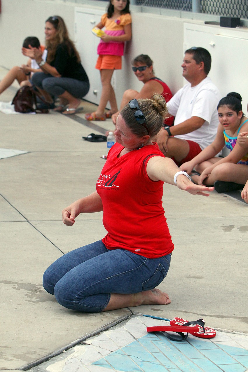 Coach Erin Bacon tries to guide some of the younger synchronized swimmers through their moves.