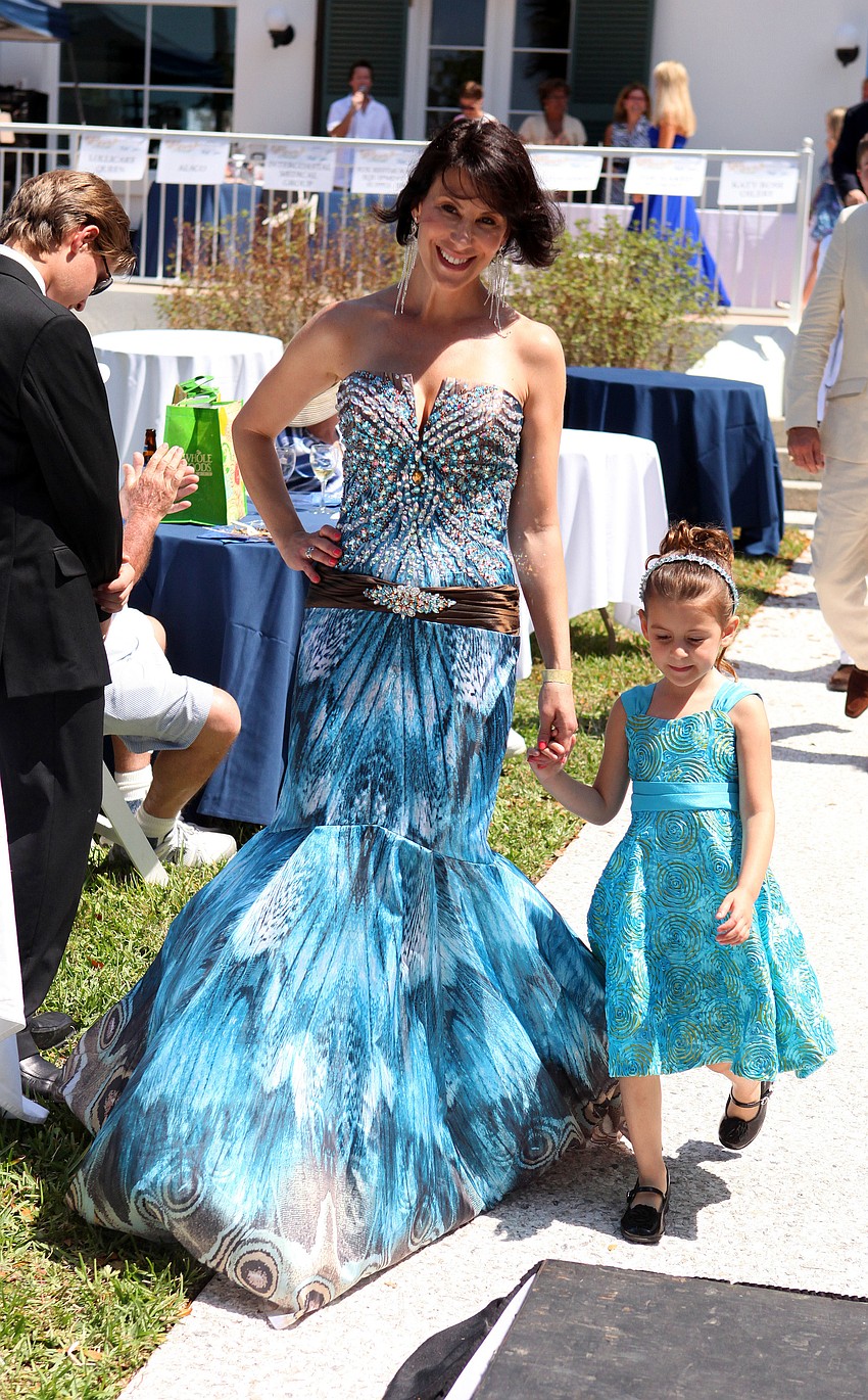 Michelle Mattison with her daughter, Gianna Mattison, 4 Â½, do the final walk down the runway.