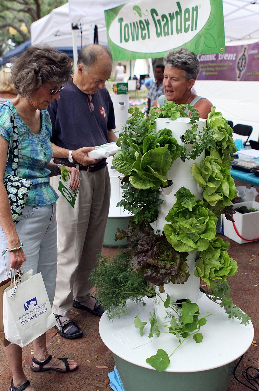 People checked out the new Tower Garden at the 2012 Natural Awakenings' EcoFest on Saturday.