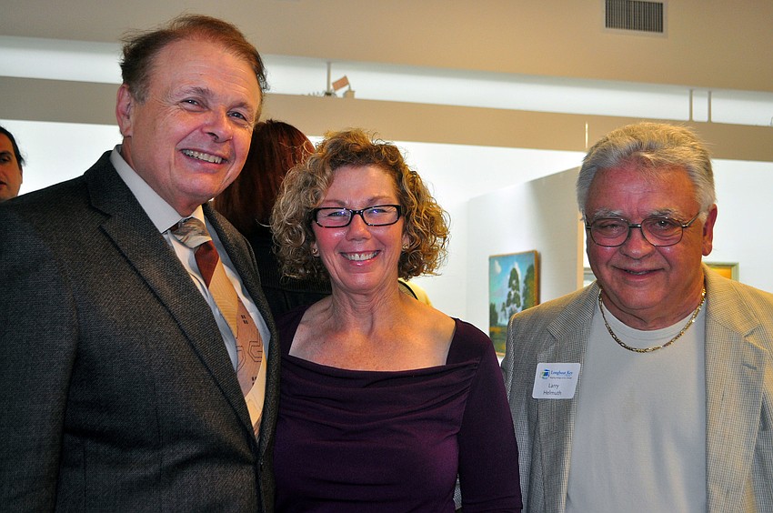Ringling College President Larry Thompson with Kathy and Larry Helmuth, whose collection was on display