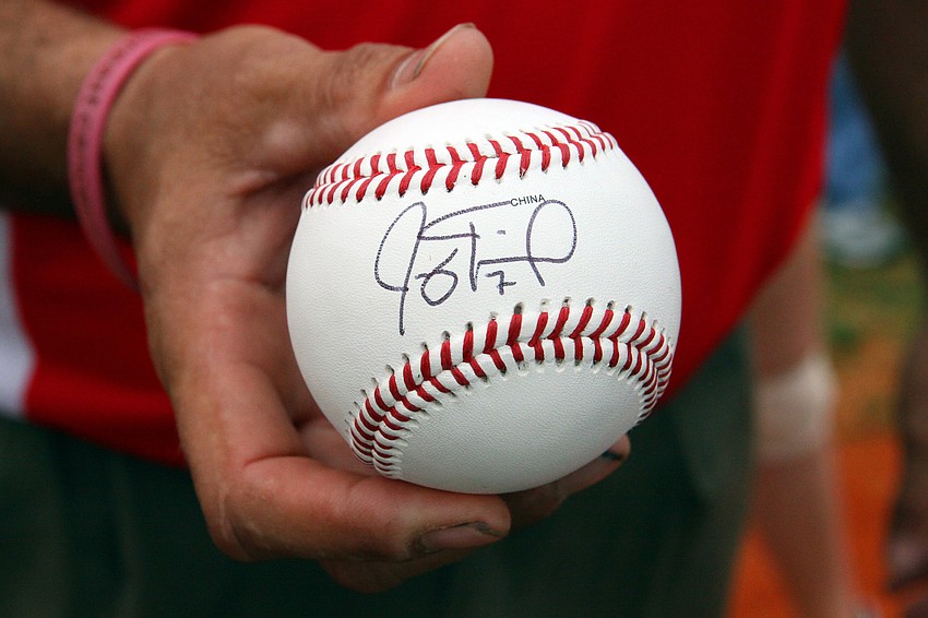 Neil Bain holds a ball signed by Joey Terdoslavich.