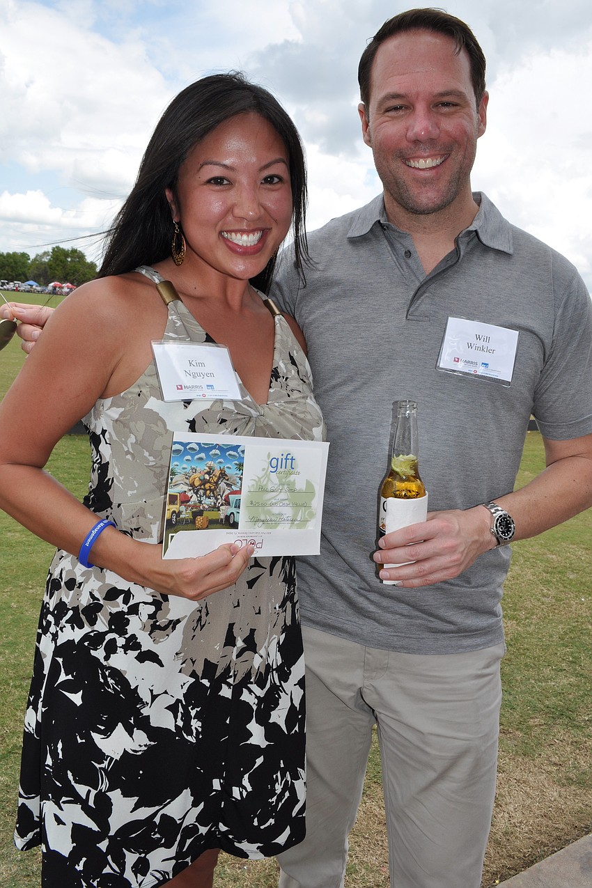 Kim Nguyen, pictured with Will Winkler, was excited about winning a gift card to the polo gift shop.