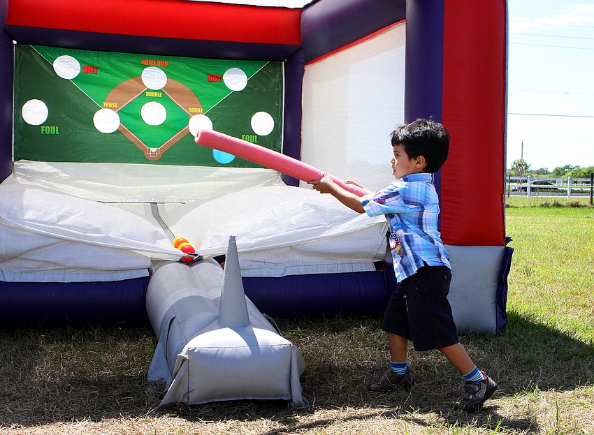 Diego Orjuela, 4, tries to hit the plastic ball with a noodle.