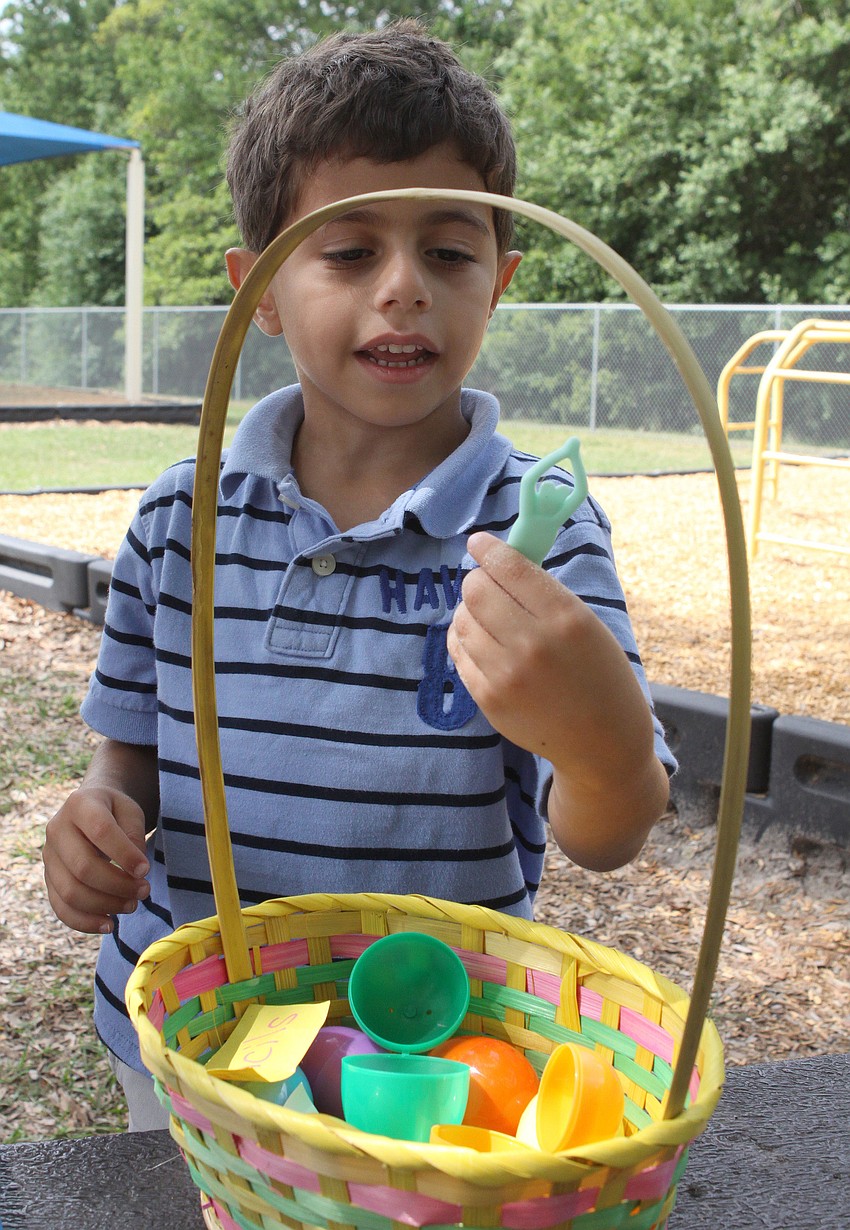 Sam Shamsey, 4, looks at one of the many prizes he found inside his Easter eggs.