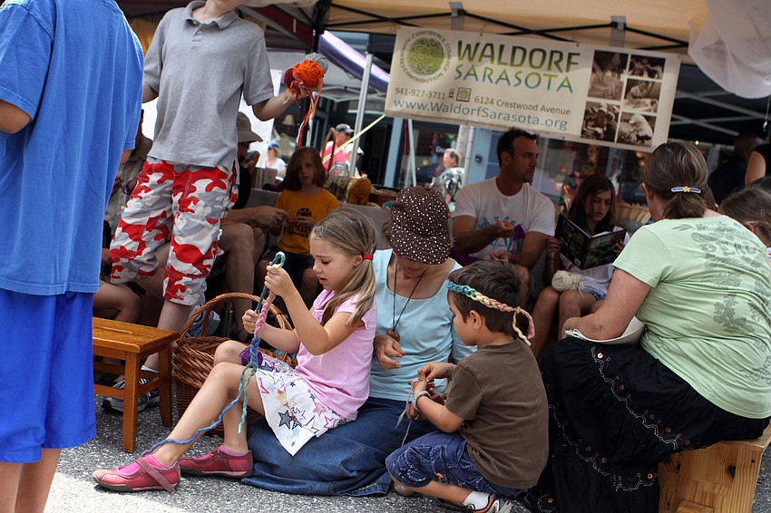 Parents and kids participate in a knit-a-thon, Saturday, April 14, during the 2012 Natural Awakenings' EcoFest.