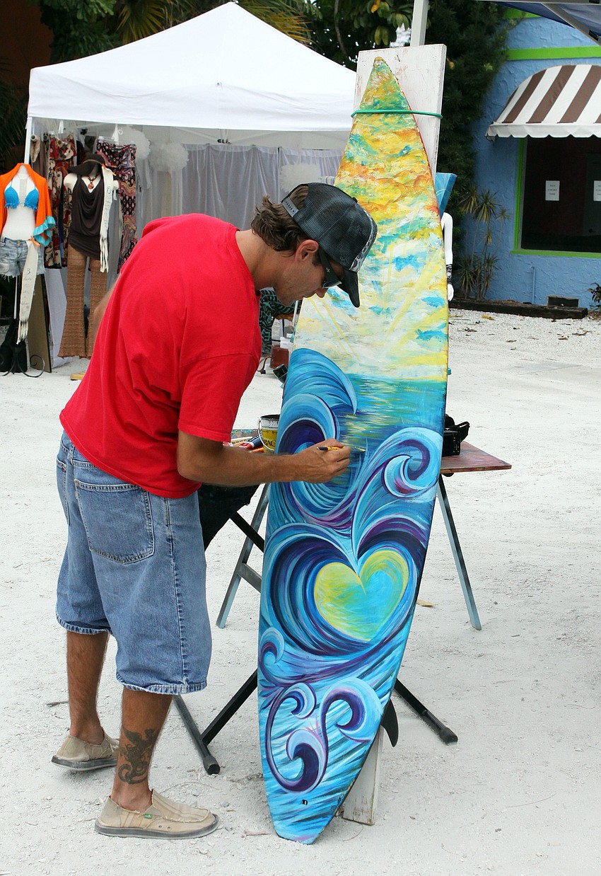 Cheeta Chad Ruis works on a piece of his artwork during Siesta Fiesta, Saturday, April 14.
