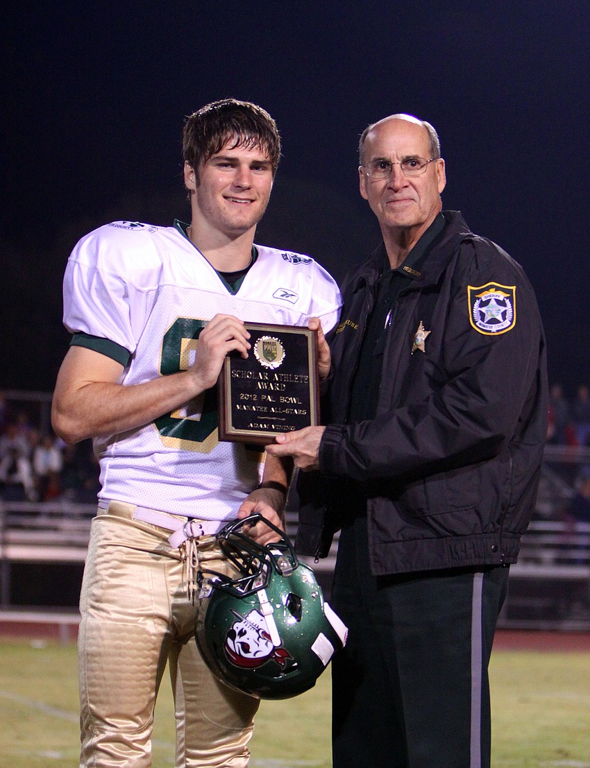 Adam Vining, 88, poses with Sheriff Brad Steube after being given Manatee County's Scholar Athlete Award.