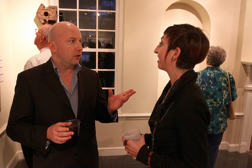 Kevin Spreitz talks to Arian Franco about her work, Friday, Jan. 13 at the opening reception of S/ART/Q's Avant Garden at the Marie Selby Botanical Gardens.