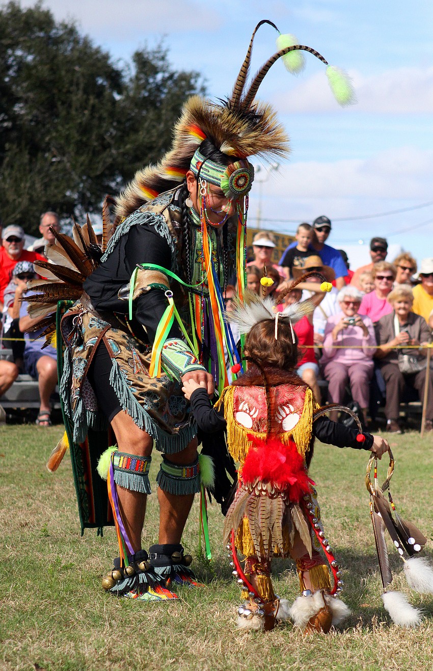 Keith Sharpshead and Dakoda Anquoe, 22 mos., do a fist bump before performing, Saturday, Jan. 28, during the Fifth Annual Sarasota Indian Festival.