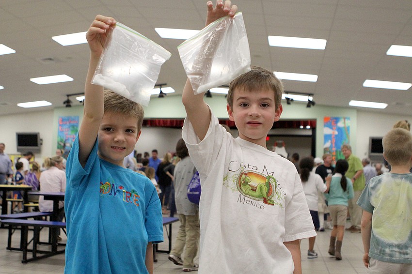 Kaes, 6, and Kean, 8, Ver Hagen show off the silly putty they made, Thursday, Feb. 16, during Science Night at Southside Elementary.