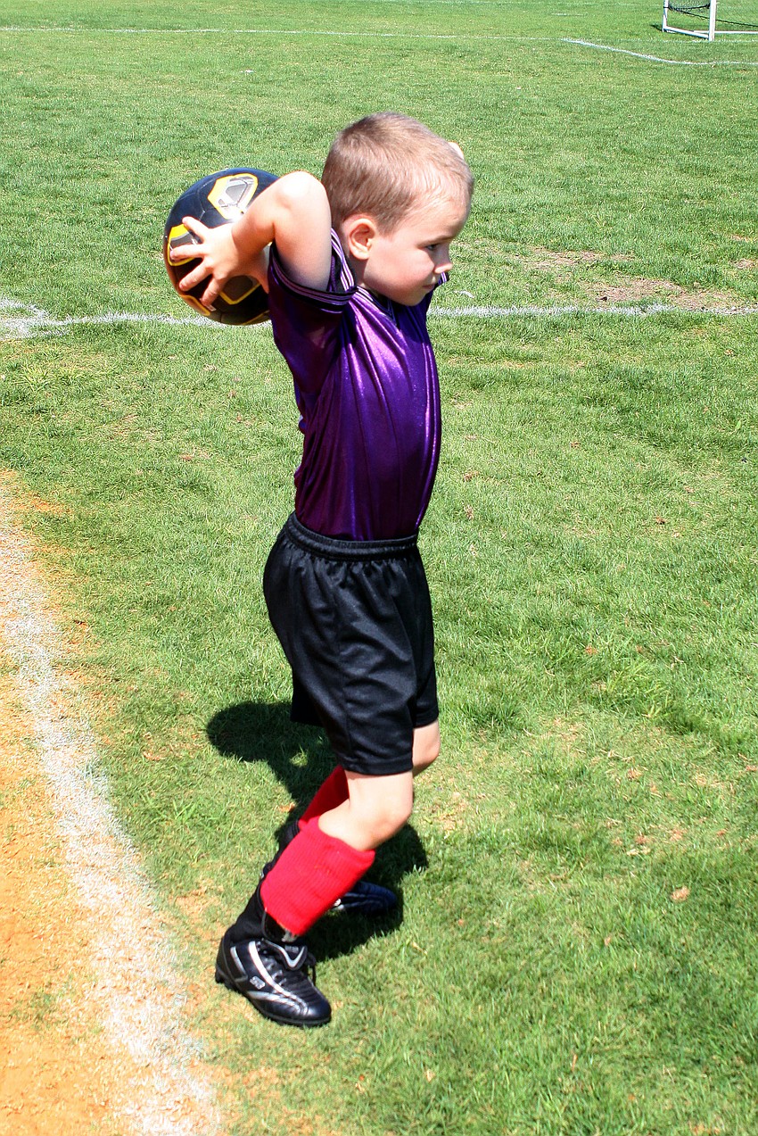 Ben Strom, 7, prepares to throw the ball back on the field.
