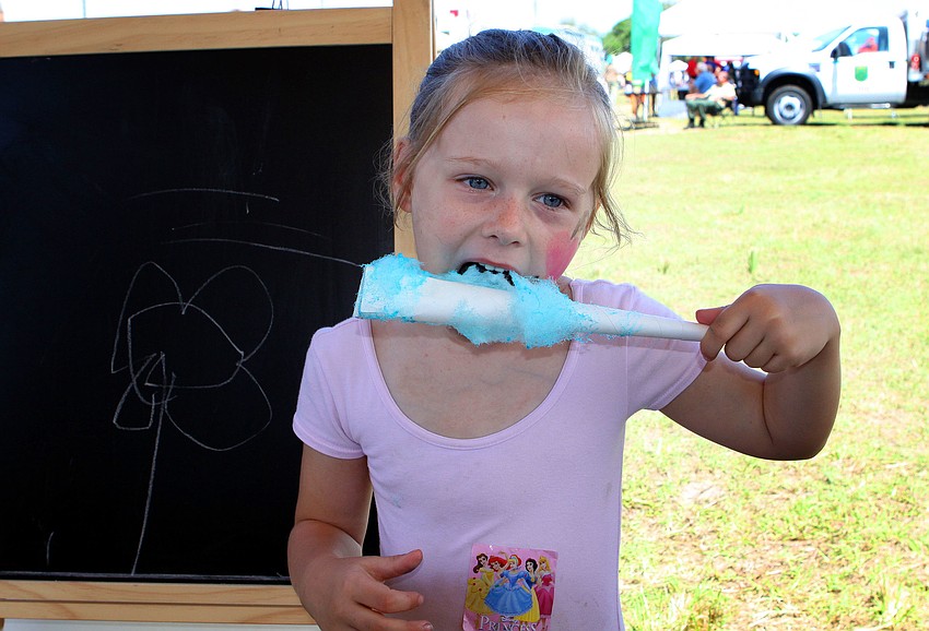 Ella Taylor, 5, enjoys eating some cotton candy.