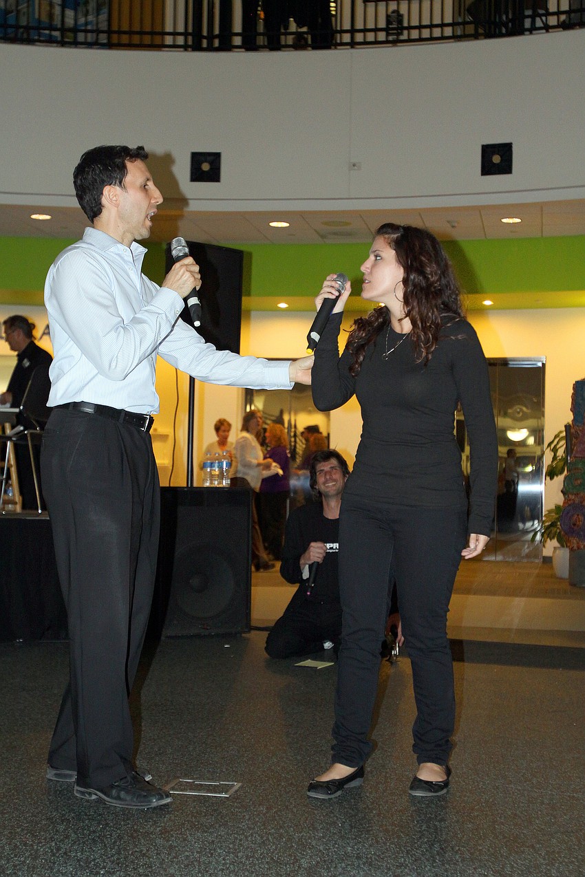 Steve Turrisi and Victoria Fragnito act out a scene while Adam Ratner holds a bicycle horn that he used to interrupt and change the scene during FST's performance at Looking Into the Crystal Ball.