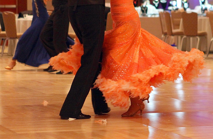 Mary Roberts' dress twirls as she and Robert Wiegman perform the Viennese Waltz, Sunday, Jan. 15, during the Sarasota Challenge at the Hyatt Regency.
