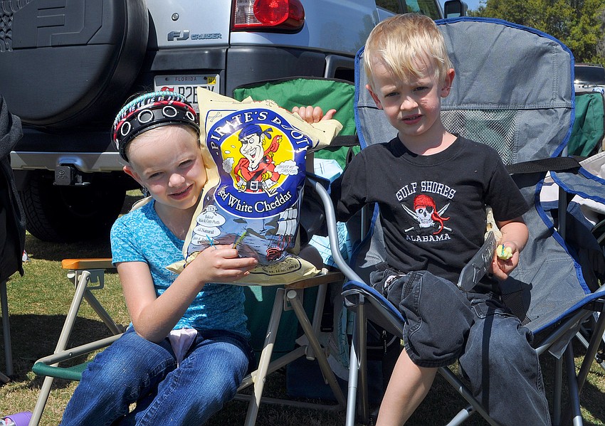 Tira, 7, and Asher, 5, VanDenhoek enjoy eating some Pirate's Booty, Sunday, March 4, at the Sarasota Polo Grounds.