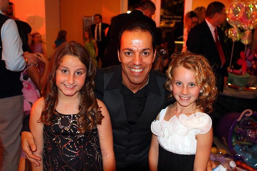 Olivia Venafro, 10, poses with Carlos and Eliza, 10, Santos