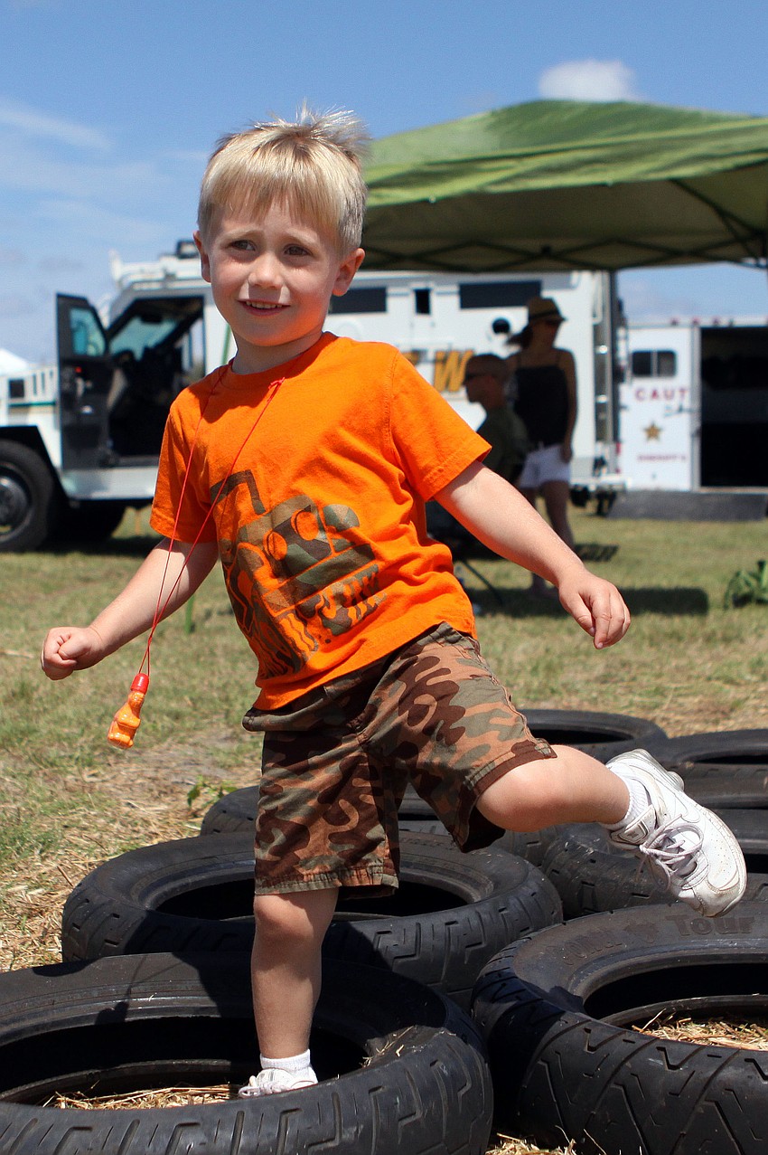 Quincy Uber, 3 Â½, goes through the tires on the obstacle course.