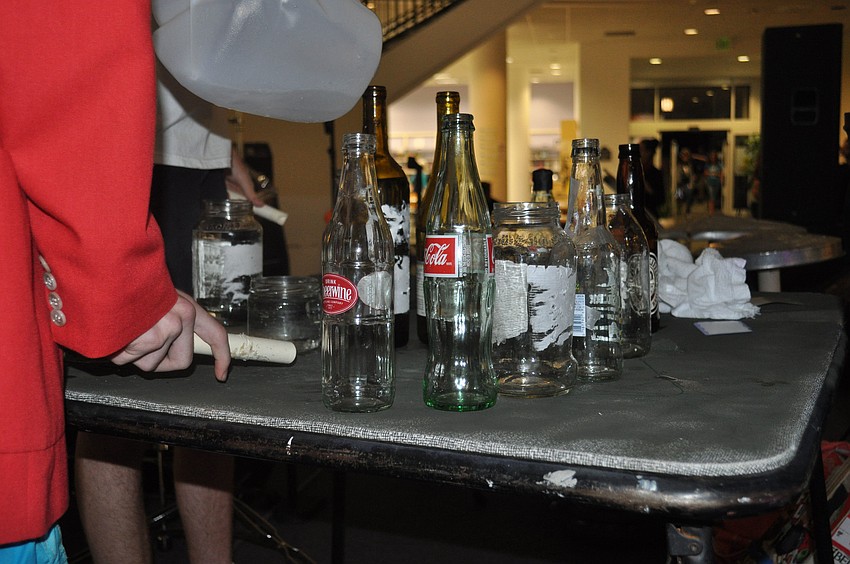 Local Band, The Garbage Men, perform using homemade instruements. These bottles are filled with varying amounts of water to determine the pitch.