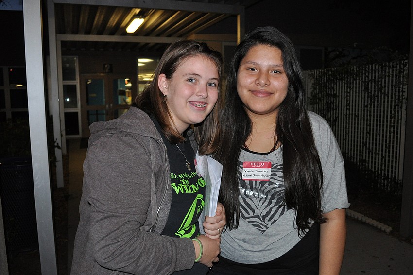 Jenny Kleer and Brenda Sanchez, of the National Junior Honor Society, passed out informational packets to guests.