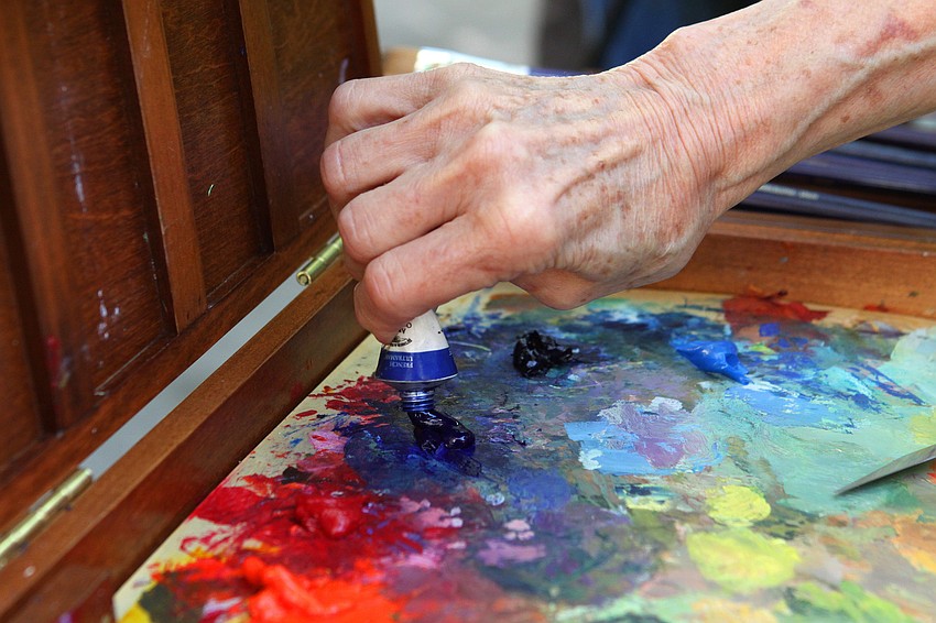 Carol Baker adds blue paint to her pallette, Thursday, Jan. 12, in Towles Court.
