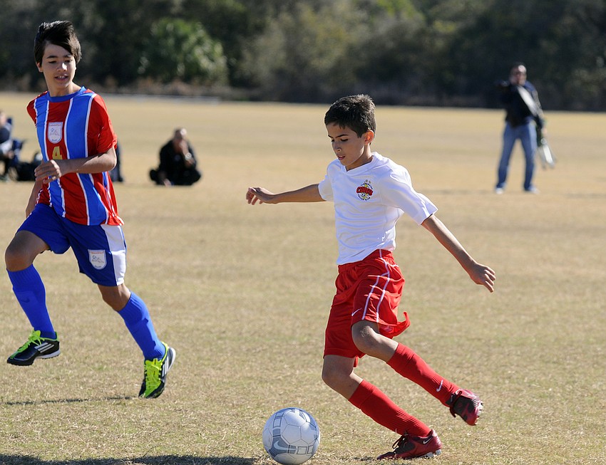 McNeal Elementary fifth-grader Nicholas Anderson looks to pass the ball during the Lakewood Ranch Chargersâ€™ game versus Florianopolis FC.