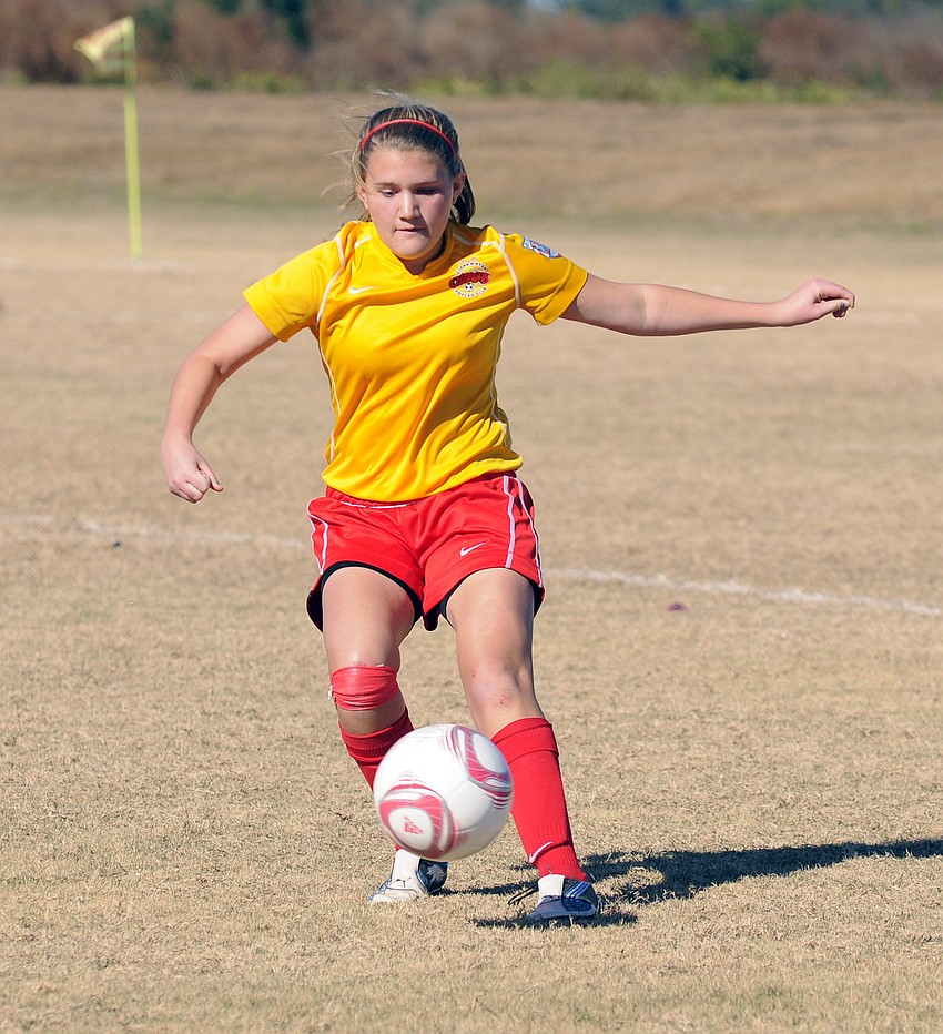 Fifteen-year-old Carly Mitchell retrieves the ball.