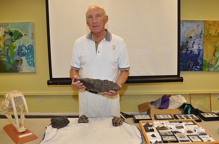 Bill Shaver holds a mammoth tooth
