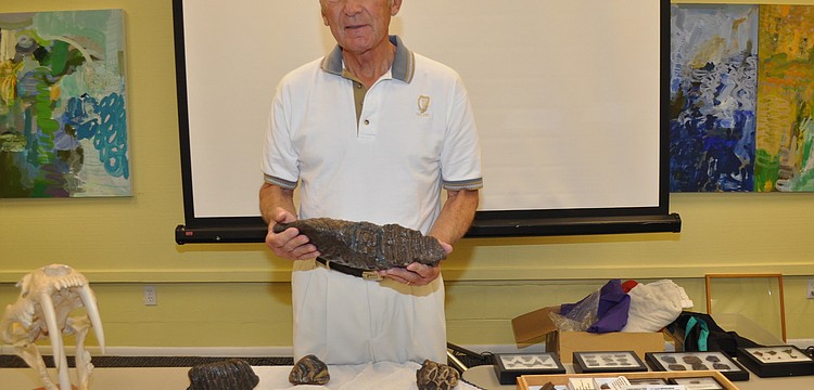 Bill Shaver holds a mammoth tooth