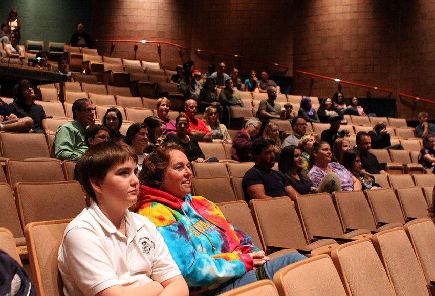 Perspective students and their parents sit and learn more about Booker High School's Visual Performing Arts program in the Booker High auditorium.