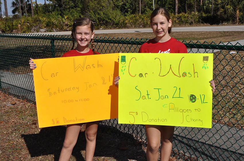 Student Council vice president Riley Lewellen, 10, and president Harley Kovalick, 10, made signs to try and drum up business.