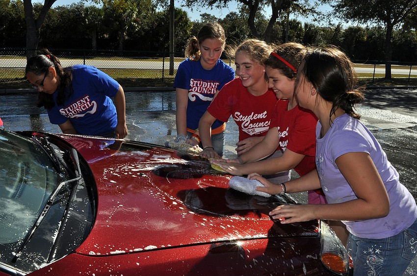 About 20 student council members spent the afternoon washing cars to raise money for the Humane Society.