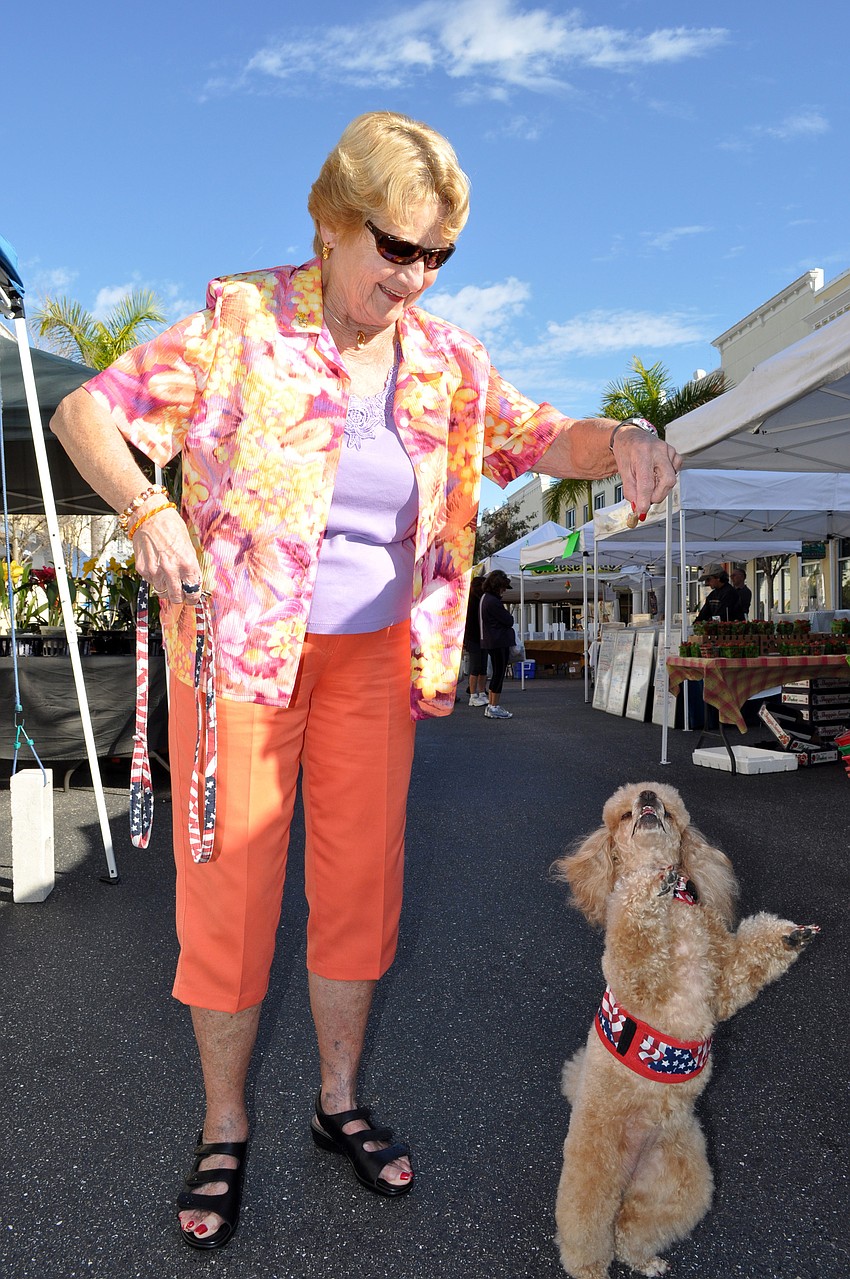 Lakewood Ranch resident Rosemary Jones brings her 3-year-old toy poodle Angel out to the market every Saturday for a spoonful of honey.