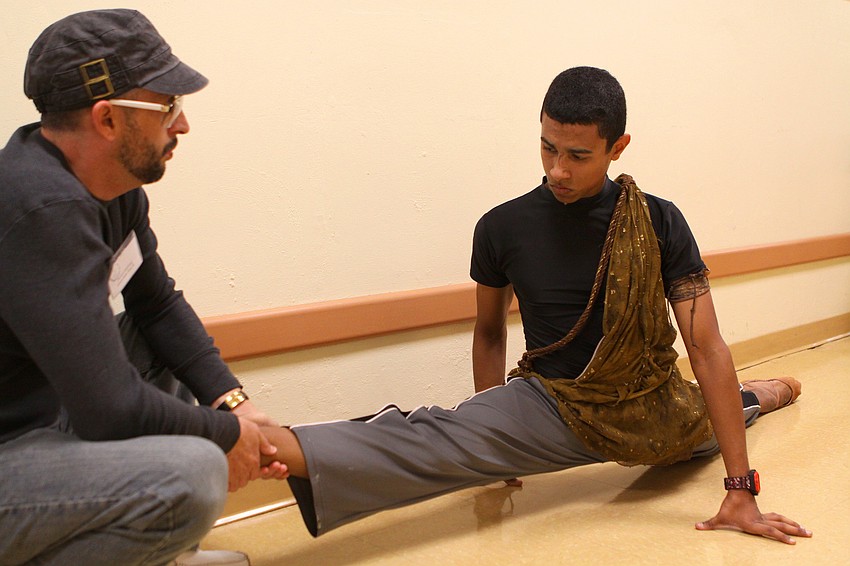 Javier Dubrocq helps Yamil Maldonado warm up backstage at the Straz Center.