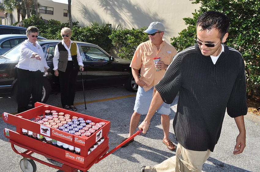 Elton Arellano wheels in the â€œBest Boss Everâ€ wagon full of Smuckerâ€™s jam with special D.M. Williams labels given as party favors for attendees of the celebration