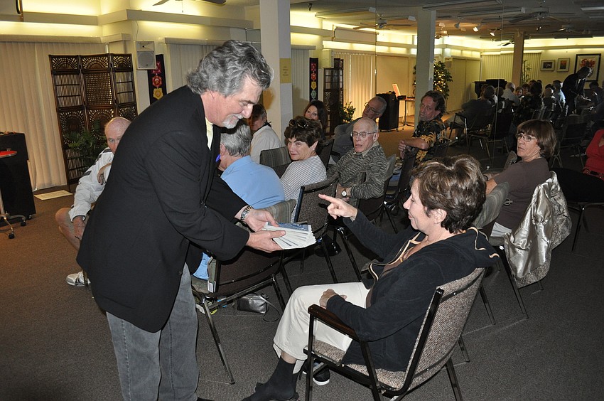 Chandler asks an audience member to pick a card, any card.