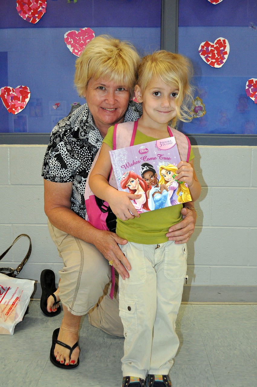 Four-year-old Kennady Woodward, pictured with her grandmother Donna Channey, picked out a Disney princess book at the book fair.