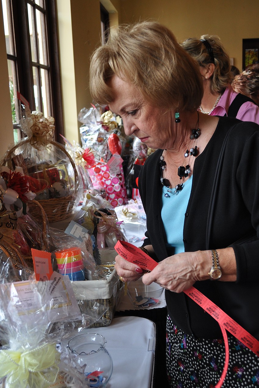 Carole Arcy checked out the silent auction items.