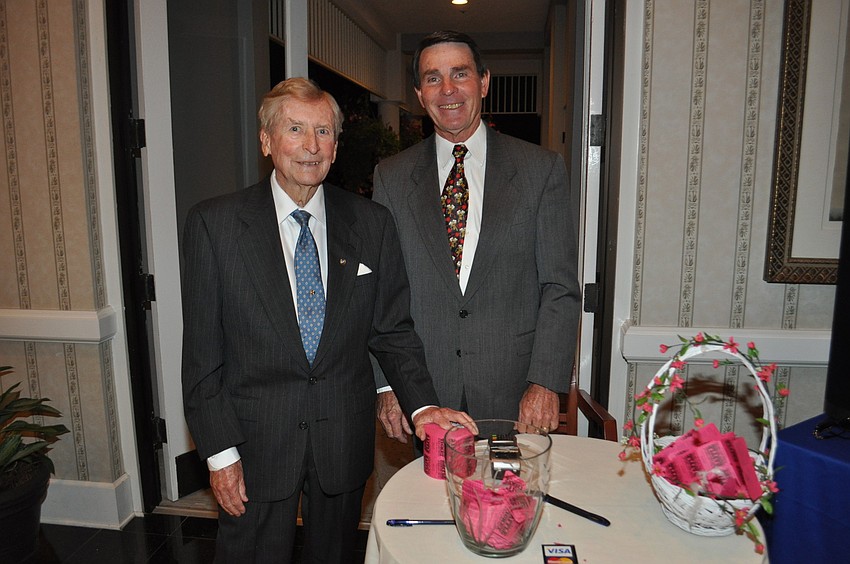 Bill Cotton and Jim Larson sell raffle tickets
