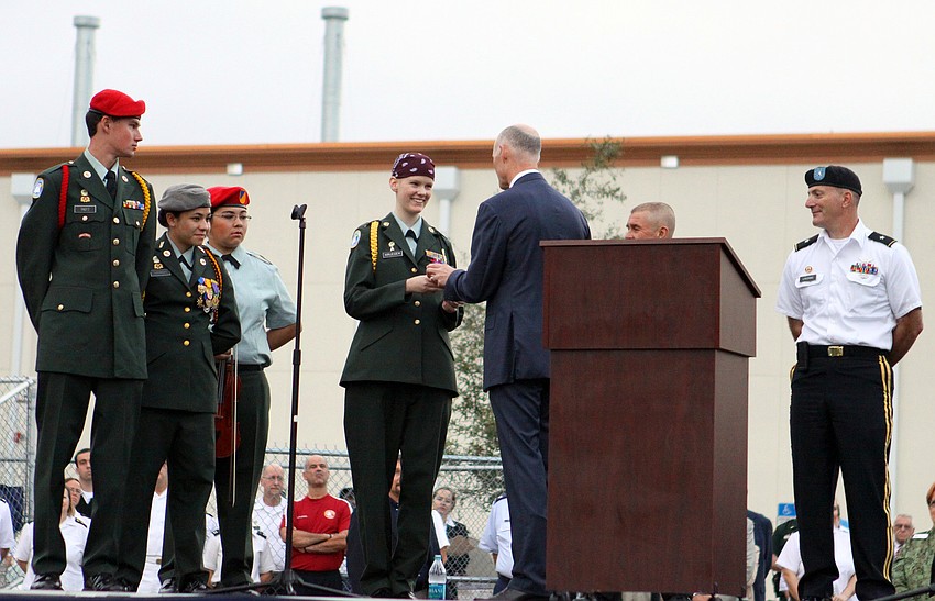 Gov. Rick Scott gave Ashley Krueger, junior, a Challenge Coin and a special pin, Friday, Feb. 17, during his visit to Sarasota Military Academy.