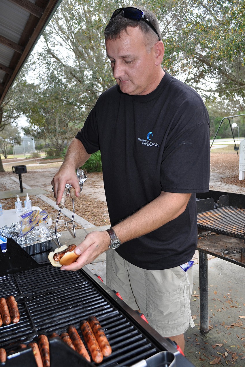 Don Fletcher prepared hot dogs for guests.