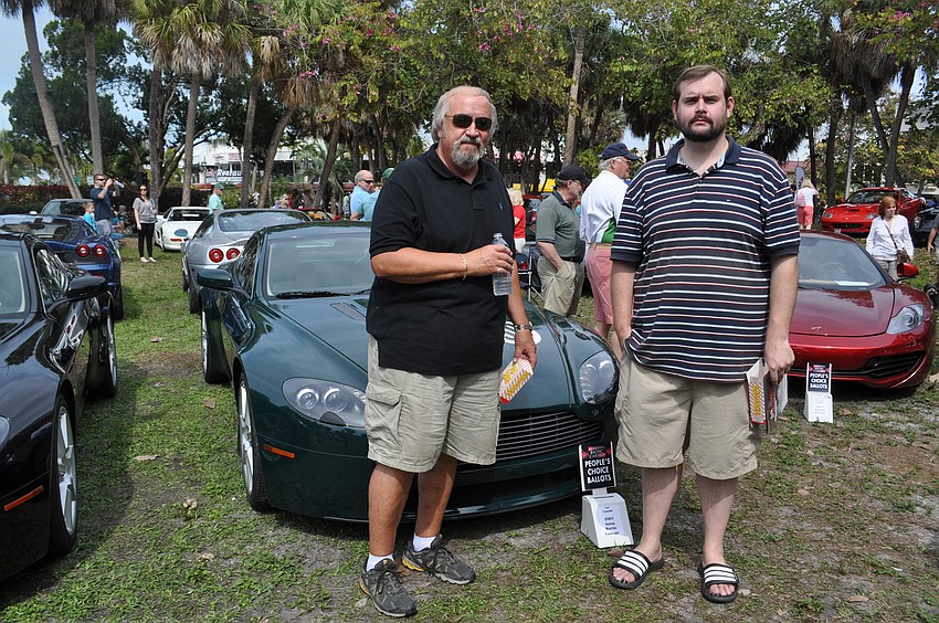 Bruce Massoth and Adam Massoth in front of an Aston Martin