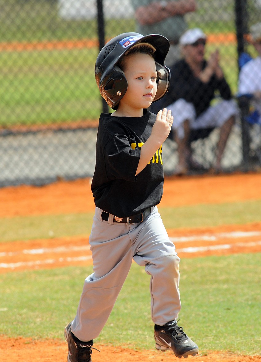 Five-year-old Camden Pope heads for first base.