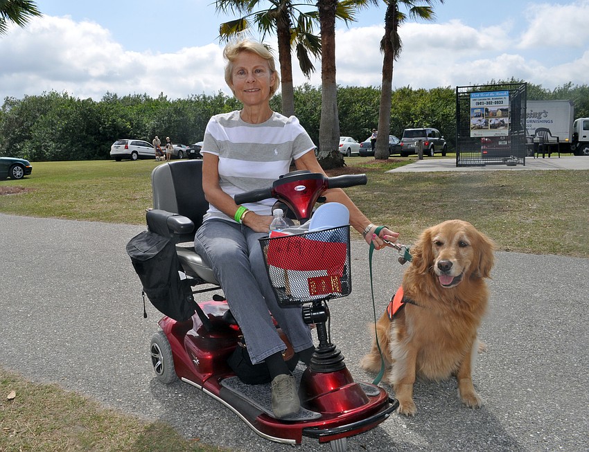Panther Ridge resident Eva Heakin, pictured with her service dog Gracie, recently started volunteering at Honor Animal Rescue.