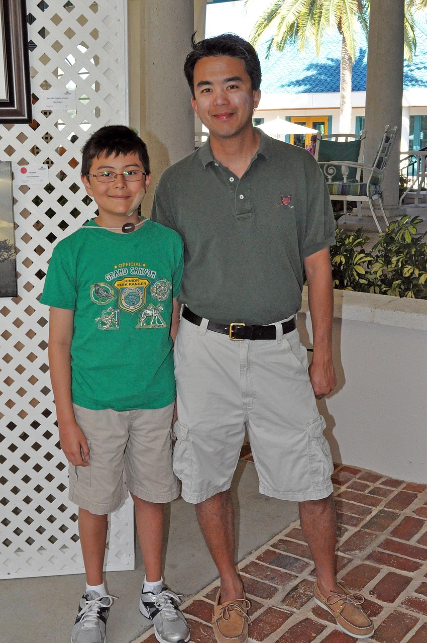 Ten-year-old Alexander Mak and his father Kelvin were the most interested in the photography exhibit.