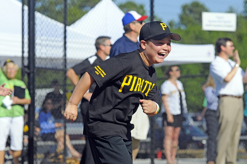 Eleven-year-old Jordan Aubin reacts after hitting an in the park grand slam to tie the game.