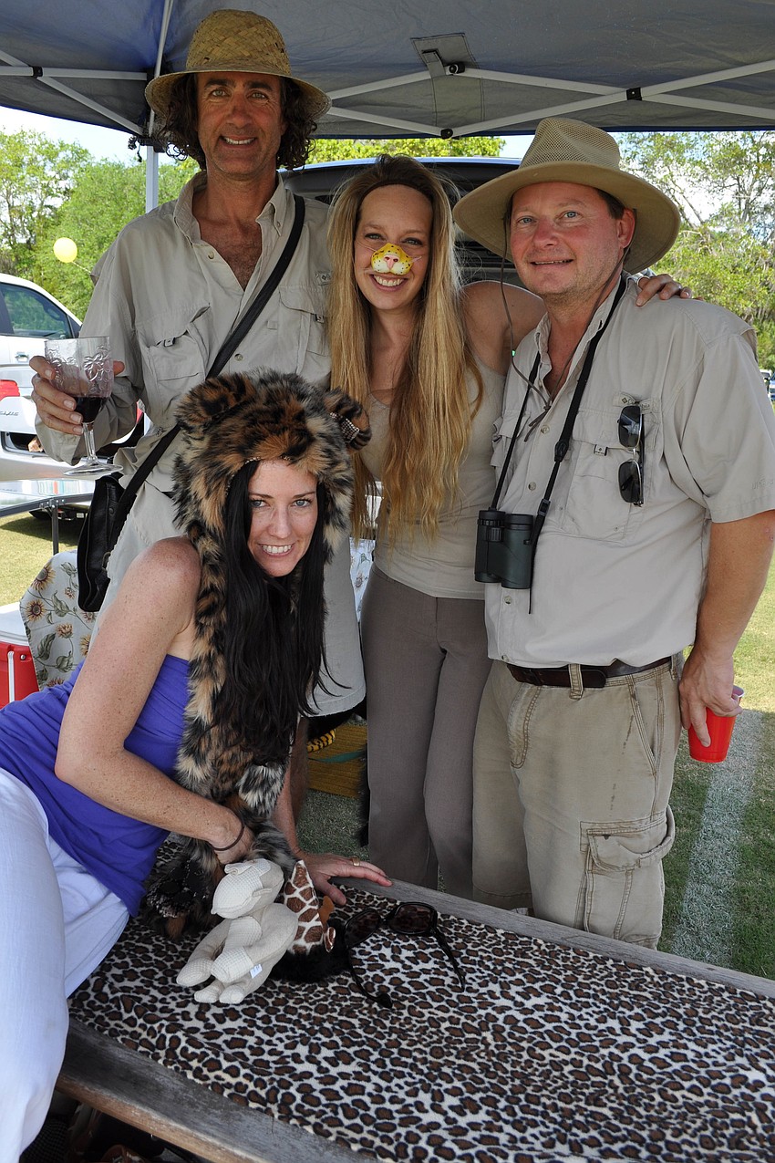 Sherri Swanson and Andy Swanson, Elizabeth Oâ€™Connor and Paul Semenec dressed for the safari theme.