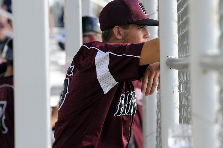 Braden River junior Alec Neuzil looks on as his teammates take the field.